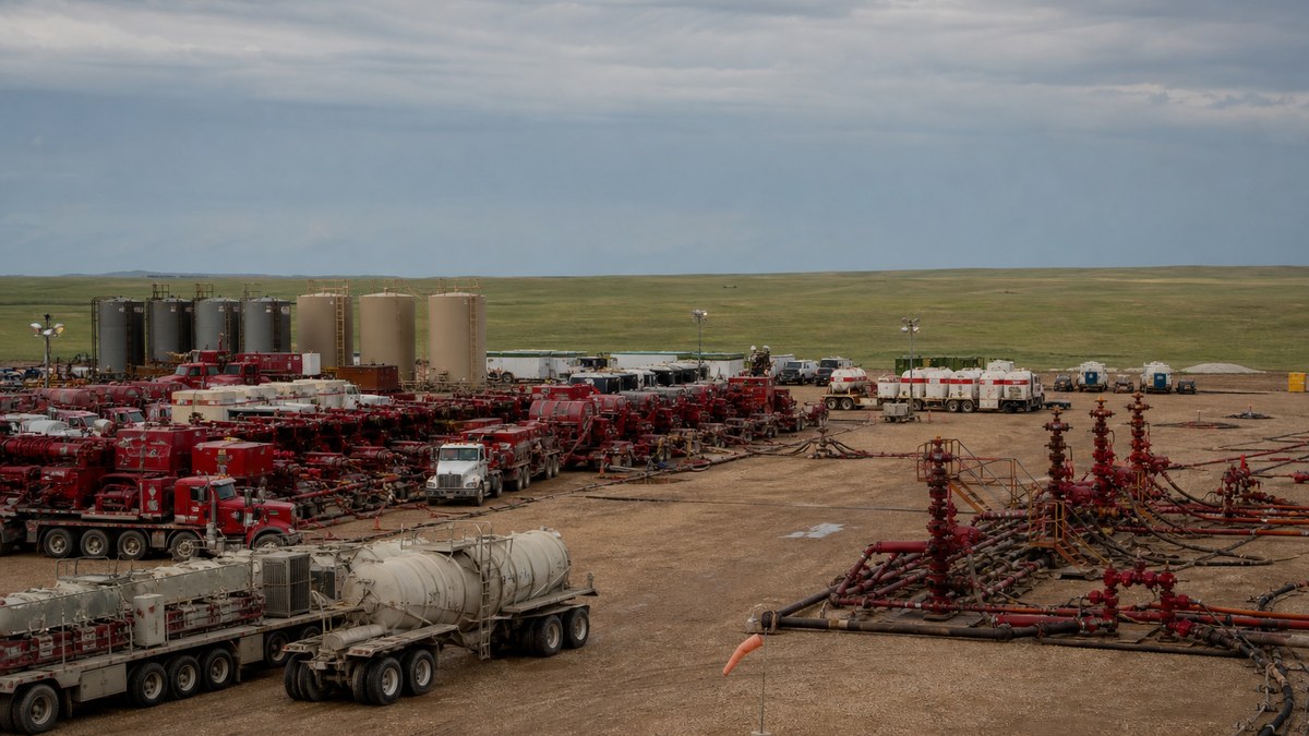 Hydraulic fracturing fleet working on a multi-well Bakken pad in western North Dakota under an overcast sky