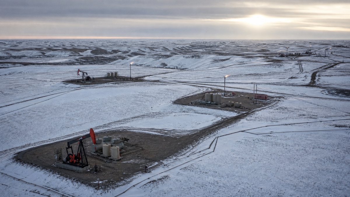 Aerial view of multiple Bakken well pads across snow-covered North Dakota prairie, the kind of field-scale area targeted by Crack the Code 2.0 phase two